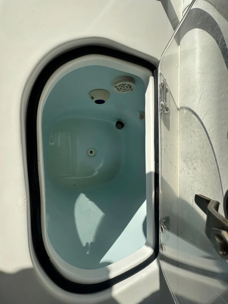 Slide: The Image of Open storage compartment on 2015 Sea Hunt Ultra 234 boat. - 14