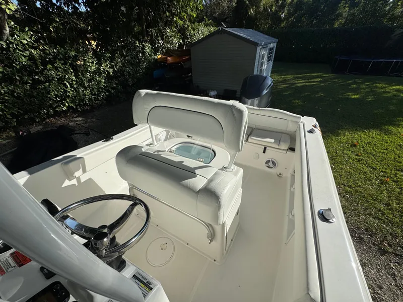 Slide: The Image of 2015 Sea Hunt Ultra 234 boat interior with steering wheel and seating. - 6