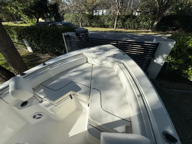 Slide: The Image of 2015 Sea Hunt Ultra 234 boat with spacious seating and sleek design. - 7
