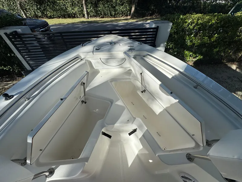 Slide: The Image of 2015 Sea Hunt Ultra 234 boat interior with open storage compartments. - 9