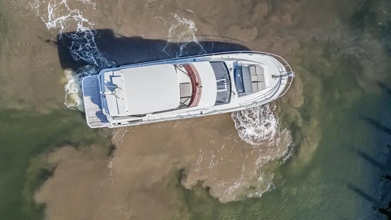 Slide: The Image of Aerial view of 2021 Prestige 520 Flybridge yacht navigating through water. - 14