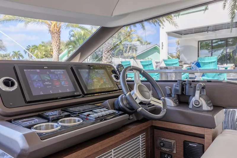 Slide: The Image of Prestige 520 Flybridge 2021 yacht helm with modern navigation displays and controls. - 32
