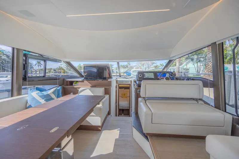 Slide: The Image of Luxurious interior of 2021 Prestige 520 Flybridge yacht with modern seating and panoramic windows. - 43