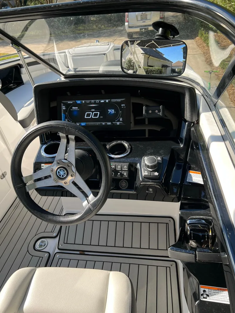 Slide: The Image of 2020 Yamaha Boats 242 Limited SE dashboard with steering wheel and digital display. - 10