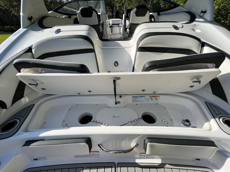 Slide: The Image of 2020 Yamaha Boats 242 Limited SE interior with open storage compartment and seating. - 12