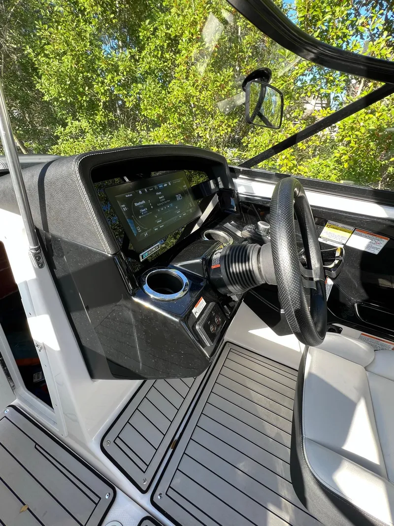 Slide: The Image of 2020 Yamaha Boats 242 Limited SE cockpit with modern dashboard and steering wheel. - 13