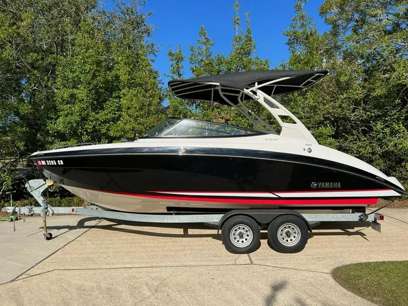 Slide: The Image of 2020 Yamaha Boats 242 Limited SE on trailer, black and white design, parked outdoors. - 22