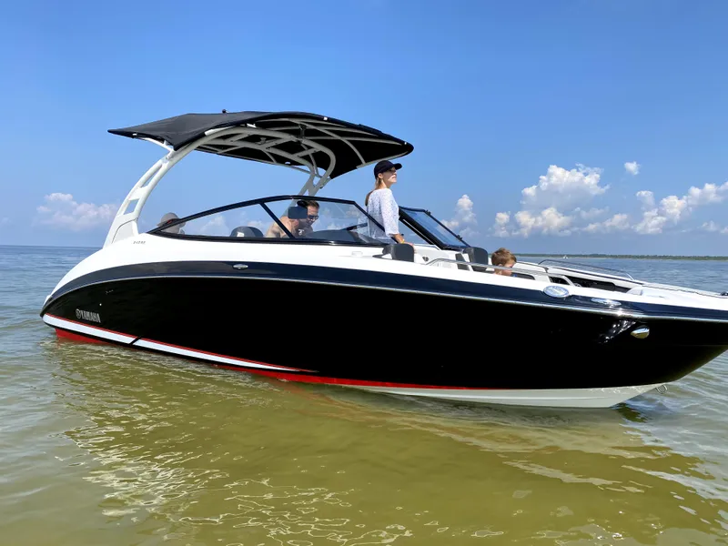 Slide: The Image of 2020 Yamaha Boats 242 Limited SE on calm water under clear blue sky. - 24