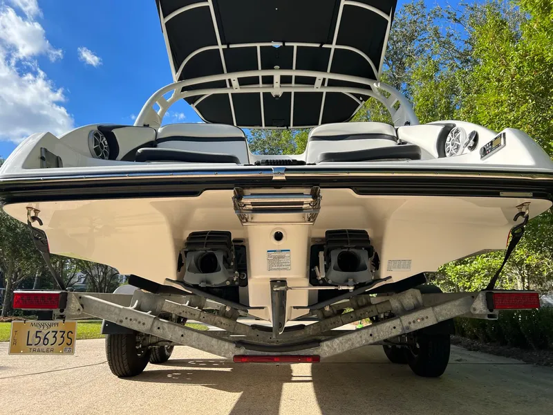 Slide: The Image of 2020 Yamaha Boats 242 Limited SE on trailer, rear view, sunny day. - 3