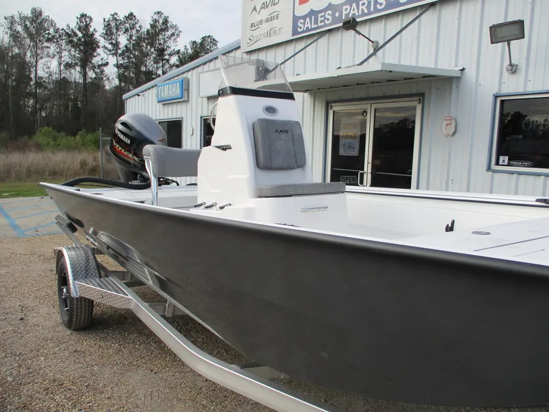 Slide: The Image of 2025 Avid 20 ROGUE CC boat parked outside dealership, showcasing sleek design and modern features. - 1