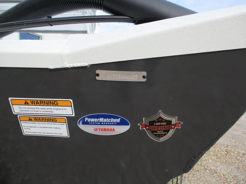 Slide: The Image of 2025 Avid 20 ROGUE CC boat with warning labels and badges. - 11