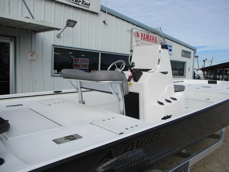 Slide: The Image of 2025 Avid 20 ROGUE CC boat with Yamaha engine, displayed outside a dealership. - 2