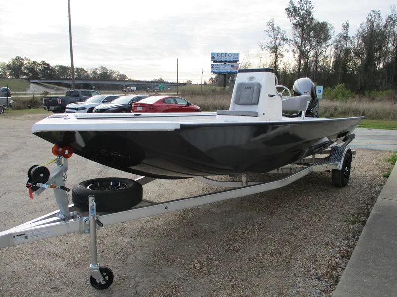 Slide: The Image of 2025 Avid 20 ROGUE CC boat on trailer in parking lot. - 7