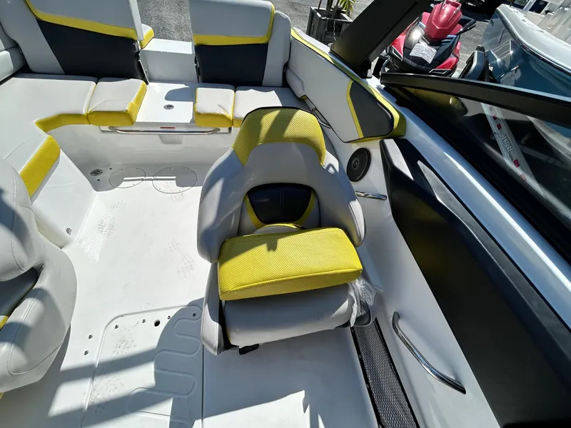 Slide: The Image of 2024 Scarab 195 ID boat interior with yellow and gray seating, modern design. - 11