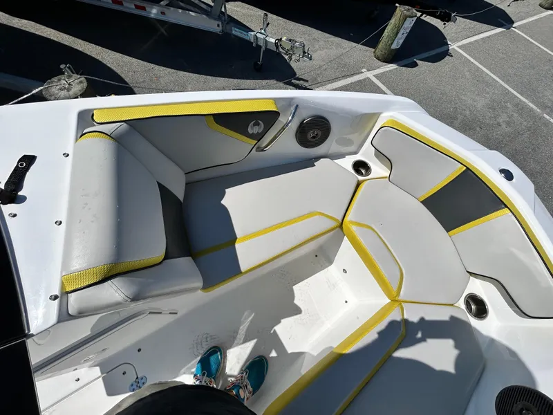 Slide: The Image of 2024 Scarab 195 ID boat interior with gray and yellow seating. - 6