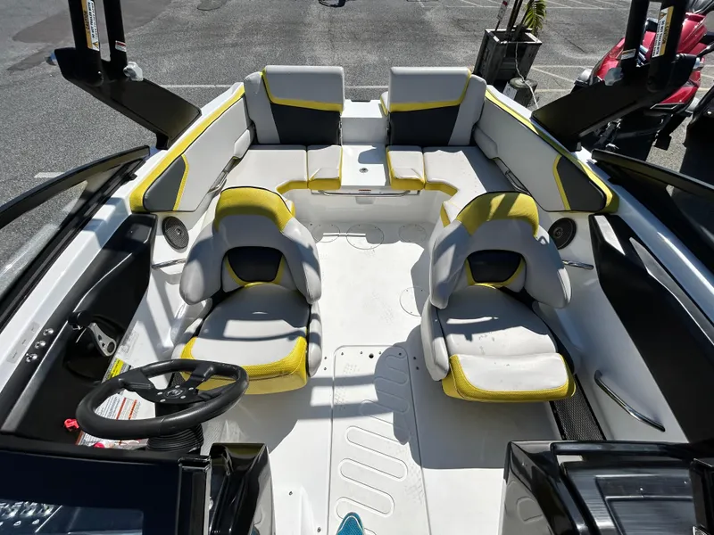 Slide: The Image of 2024 Scarab 195 ID boat interior with yellow-accented seating and modern design. - 8