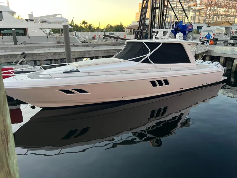 Slide: The Image of 2019 Intrepid 475 Sport Yacht docked at marina, reflecting on calm water. - 1