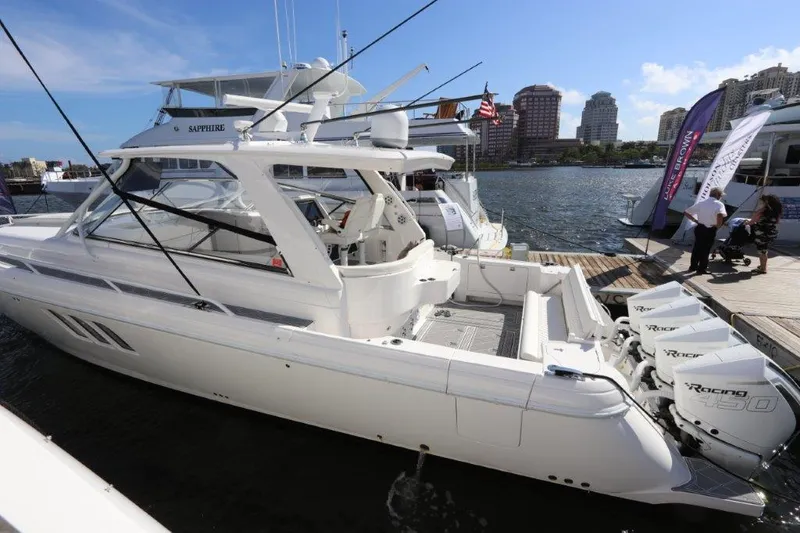 Slide: The Image of 2019 Intrepid 475 Sport Yacht docked at marina with city skyline. - 14