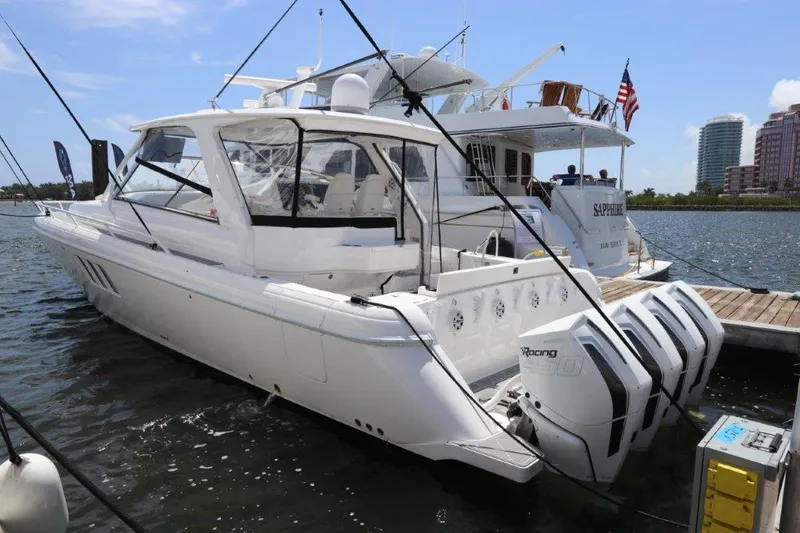 Slide: The Image of 2019 Intrepid 475 Sport Yacht docked with triple outboard engines. - 15