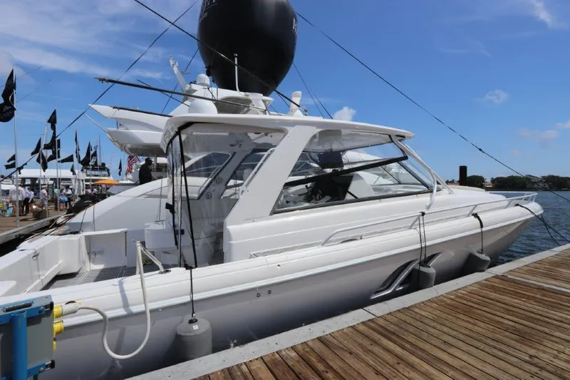 Slide: The Image of 2019 Intrepid 475 Sport Yacht docked at marina under clear blue sky. - 16