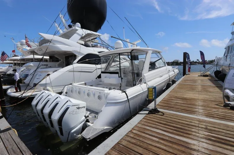Slide: The Image of 2019 Intrepid 475 Sport Yacht docked with triple outboard engines. - 17