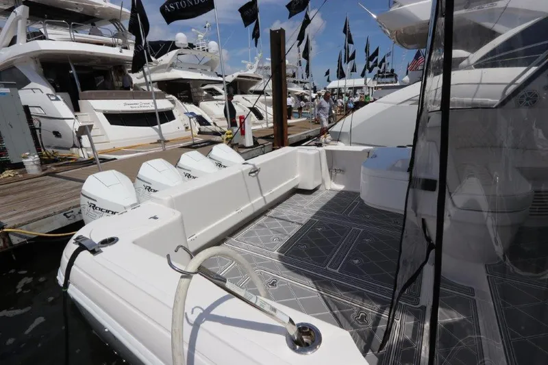 Slide: The Image of 2019 Intrepid 475 Sport Yacht docked with powerful outboard engines. - 21