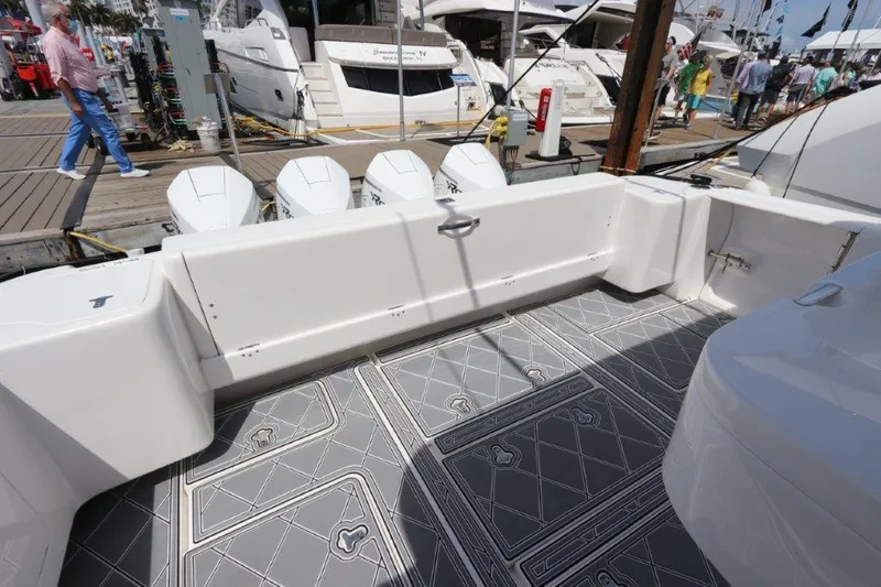 Slide: The Image of 2019 Intrepid 475 Sport Yacht deck with outboard engines at a marina. - 23