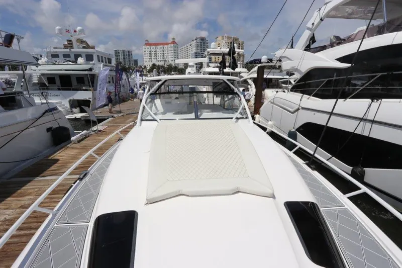Slide: The Image of 2019 Intrepid 475 Sport Yacht docked at marina, surrounded by other boats. - 28