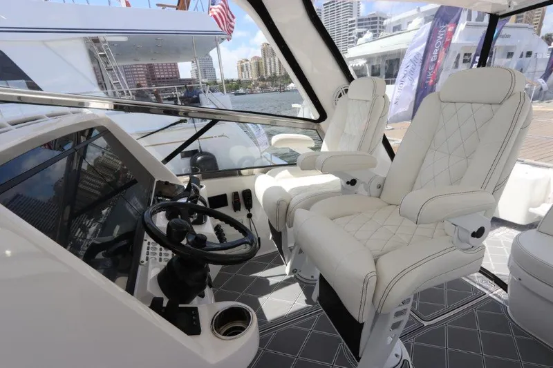 Slide: The Image of Interior of 2019 Intrepid 475 Sport Yacht with luxurious seating and modern controls. - 36