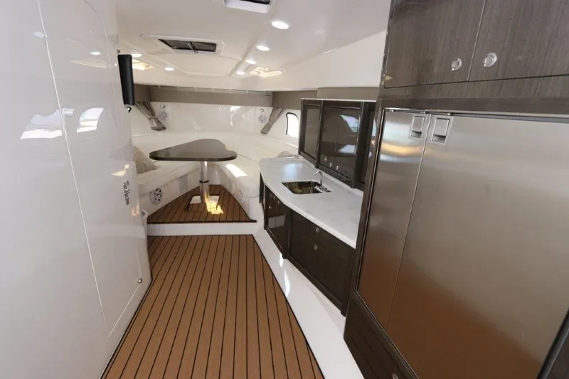 Slide: The Image of Interior of 2019 Intrepid 475 Sport Yacht with modern kitchen and seating area. - 43