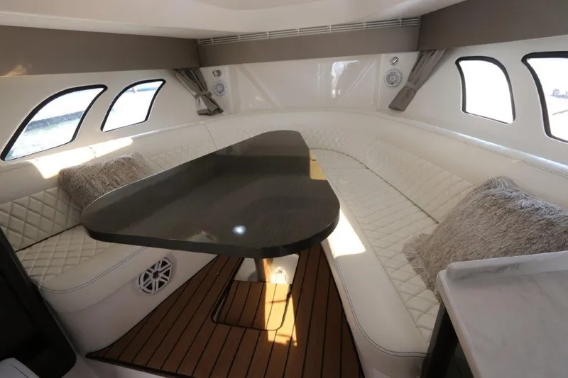 Slide: The Image of Luxurious interior of 2019 Intrepid 475 Sport Yacht with plush seating and elegant table. - 47