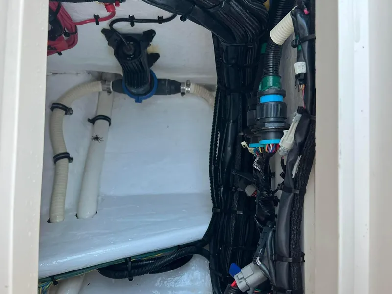 Slide: The Image of Engine compartment of 2019 Intrepid 475 Sport Yacht with visible wiring and hoses. - 9
