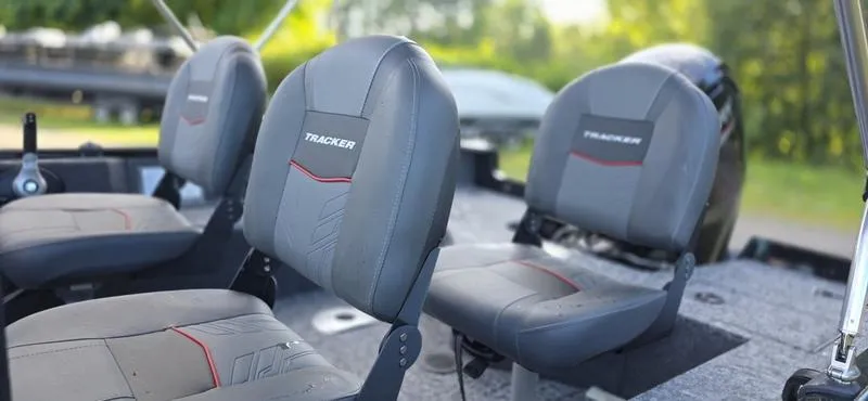 Slide: The Image of 2025 Tracker PG V16 WT boat seats with gray upholstery and red accents. - 10