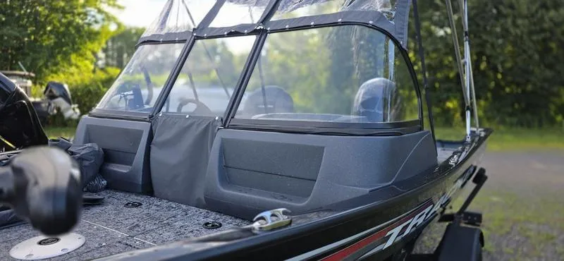 Slide: The Image of 2025 Tracker PG V16 WT boat with windshield, parked outdoors. - 5