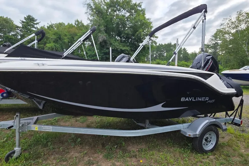 The Image of 2025 Bayliner M15 boat on trailer, black exterior, parked outdoors. - 0