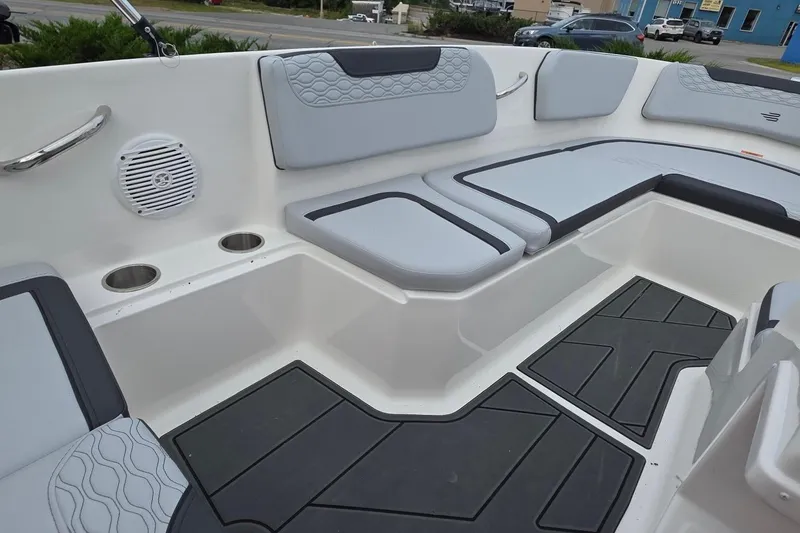 Slide: The Image of 2025 Bayliner M15 boat interior with cushioned seating and cup holders. - 12