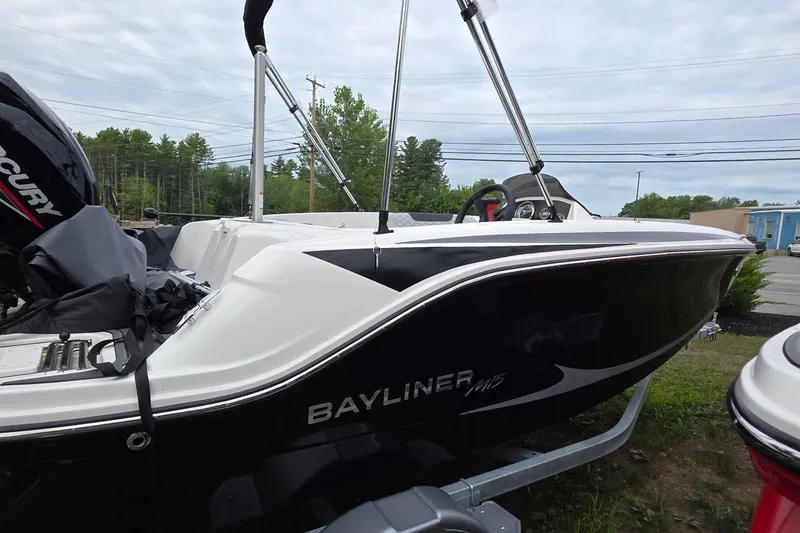 Slide: The Image of 2025 Bayliner M15 boat with Mercury engine, parked outdoors on a trailer. - 19