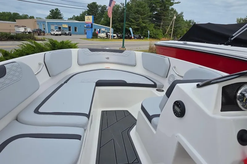 Slide: The Image of 2025 Bayliner M15 boat interior with gray seating and modern dashboard. - 2