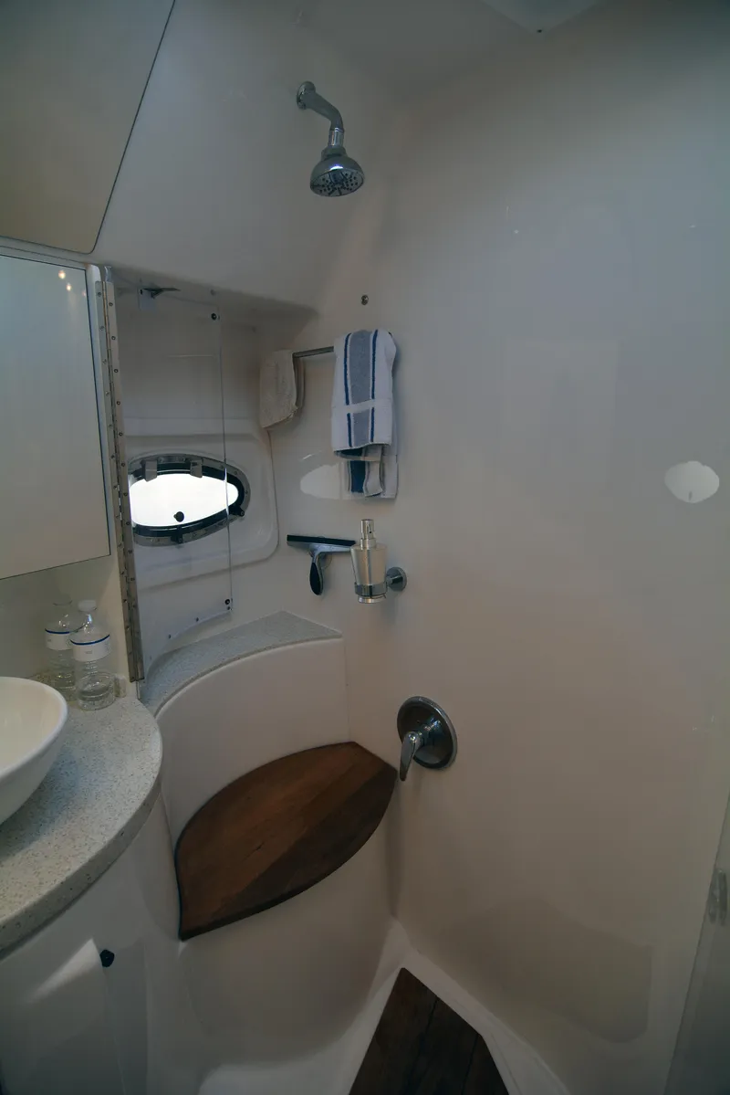 Slide: The Image of 2018 Regal 46 Sport Coupe bathroom with shower, wooden seat, and modern fixtures. - 24