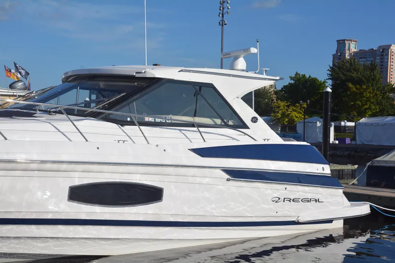 Slide: The Image of 2018 Regal 46 Sport Coupe yacht docked, showcasing sleek design and modern features. - 4