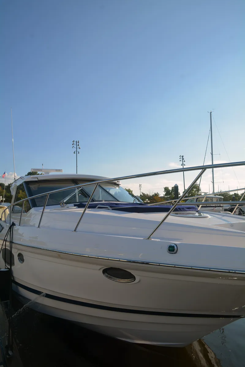 Slide: The Image of 2018 Regal 46 Sport Coupe yacht docked under clear blue sky. - 6