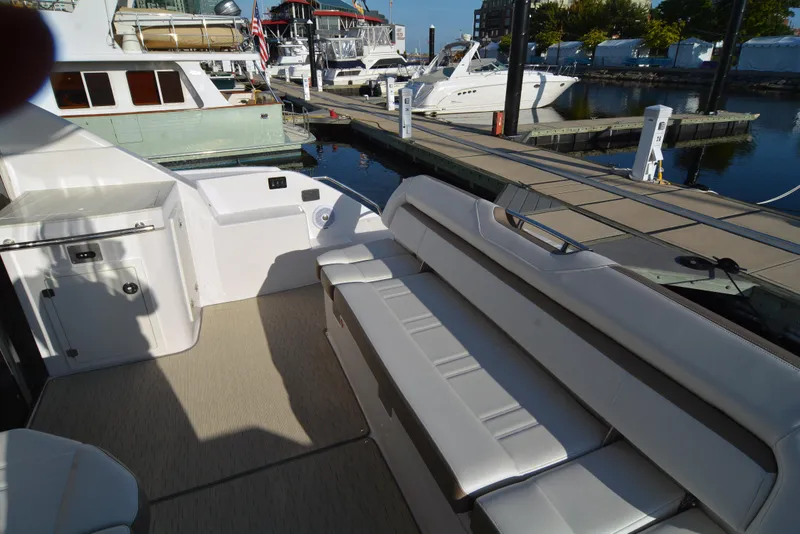 Slide: The Image of 2018 Regal 46 Sport Coupe yacht interior with seating at marina. - 9