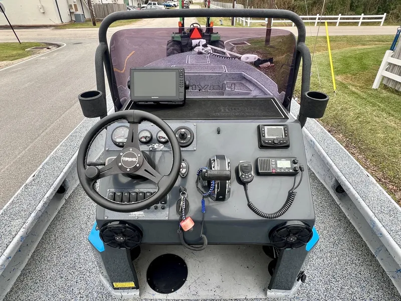 Slide: The Image of 2021 Haynie 25 Magnum boat dashboard with steering wheel and navigation equipment. - 10