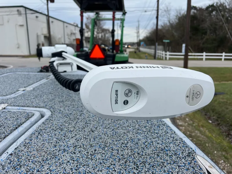 Slide: The Image of Minn Kota Riptide motor on 2021 Haynie 25 Magnum boat, parked on a street. - 16