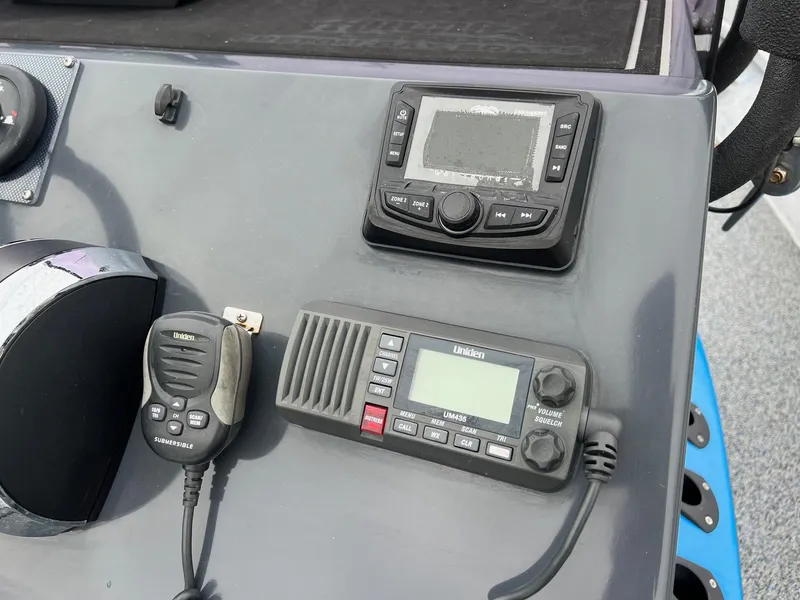 Slide: The Image of 2021 Haynie 25 Magnum boat dashboard with radio and navigation equipment. - 17