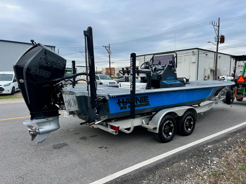 Slide: The Image of 2021 Haynie 25 Magnum boat on trailer with powerful outboard motor. - 4