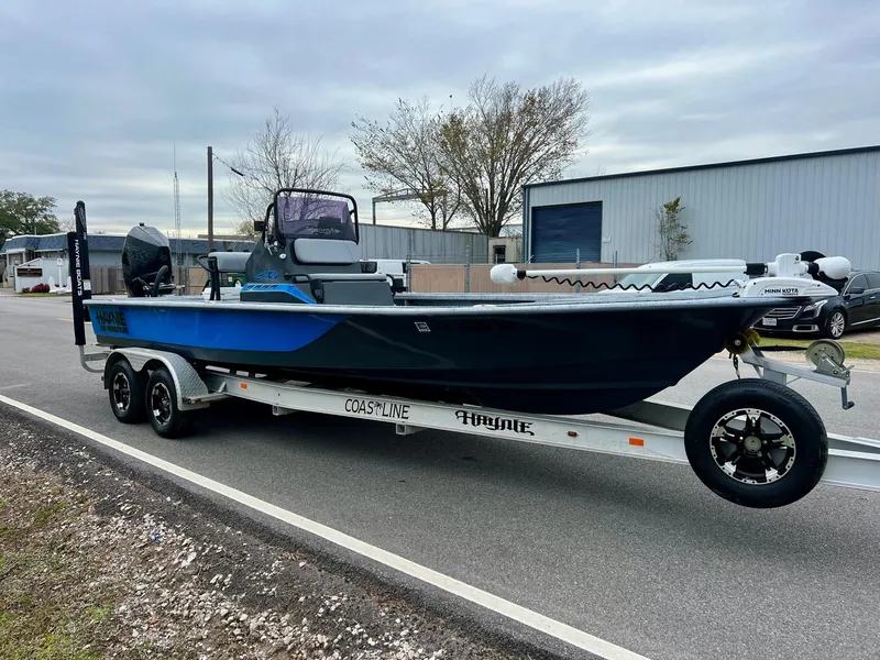 Slide: The Image of 2021 Haynie 25 Magnum boat on trailer, parked on roadside. - 5