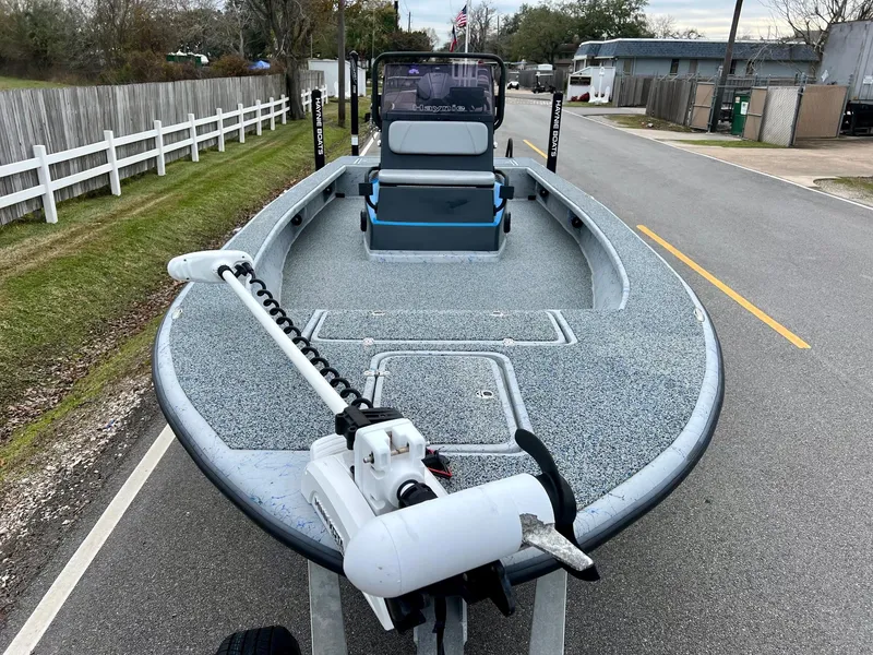 Slide: The Image of 2021 Haynie 25 Magnum boat on trailer, parked on a residential street. - 6
