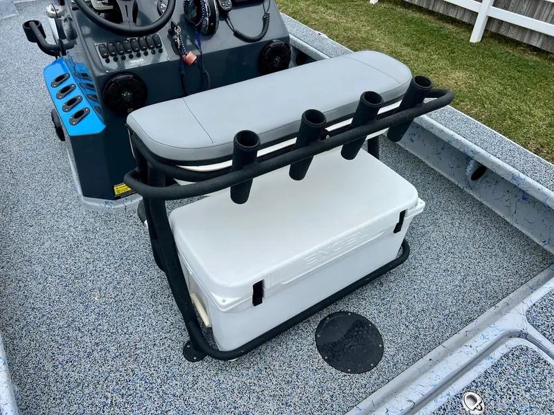 Slide: The Image of 2021 Haynie 25 Magnum boat interior with rod holders and cooler. - 8