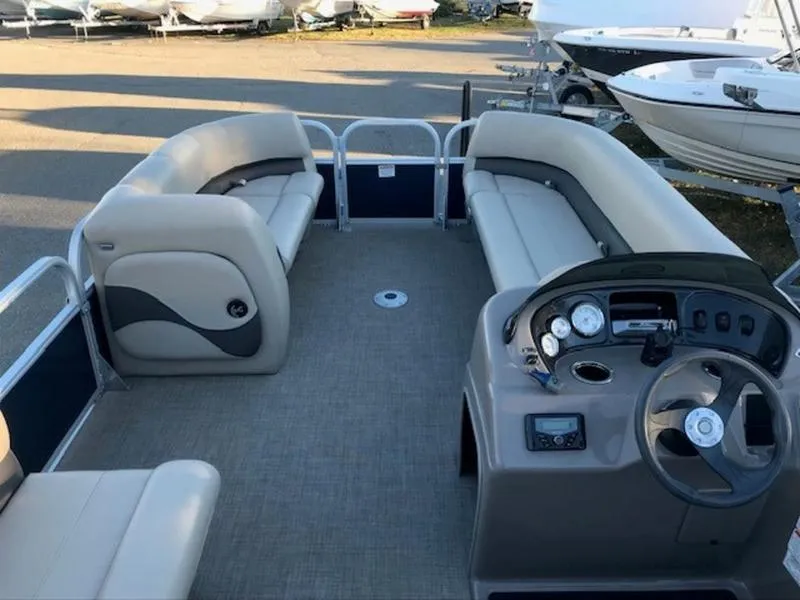 Slide: The Image of 2022 Sun Tracker PB 18 DLX pontoon boat interior with seating and steering console. - 10